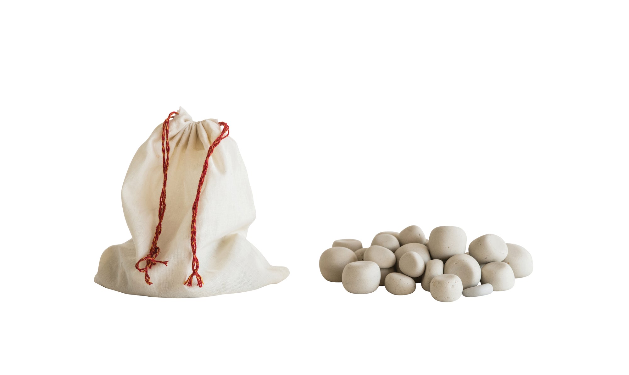 muslin bag next to small pile of stone pebbles.